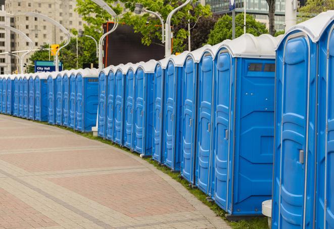 a line of portable restrooms at an outdoor wedding, catering to guests with style and comfort in Bristol